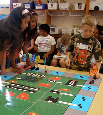 Kids gather around an equal opportunity board game.