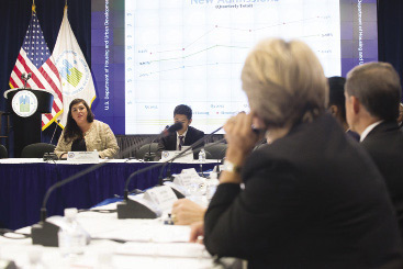 Policymakers in discussion around a conference table.