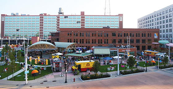 A refurbished derelict industrial lot, now an attractive public space with green areas, where people gather for concerts and other events.