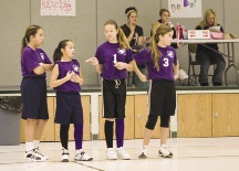 Four middle school girls participating in an unnamed extracurricular activity at school.