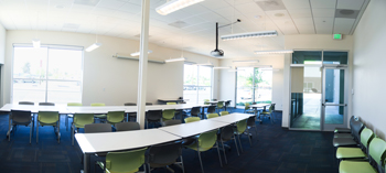 Photograph showing the interior of a training room with tables and chairs.