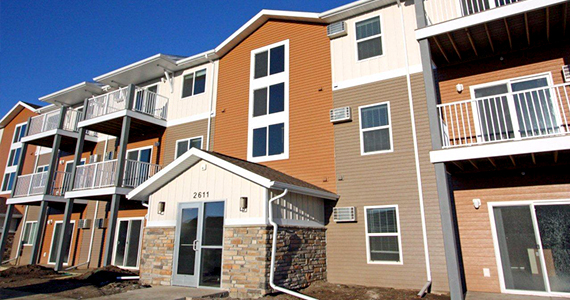 View from street level of a portion of the front façade of Patterson Heights Apartments, a 3-story building.