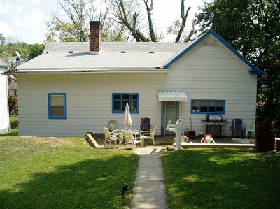 A photograph taken at ground level showing the rear façade of a one-story, single-family detached house that was selected for renovations under the Fairmont-Morgantown Housing Authority’s home repair program for veterans.