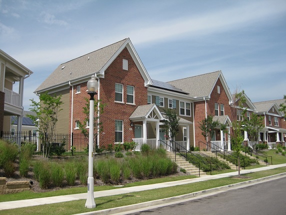 Photograph of five two-story townhouses.