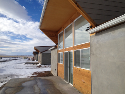 Image of compressed earth block homes surrounded by snowy ground on the Crow Indian Reservation.