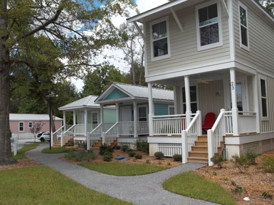 An image of A cluster of four houses in a neighborhood.