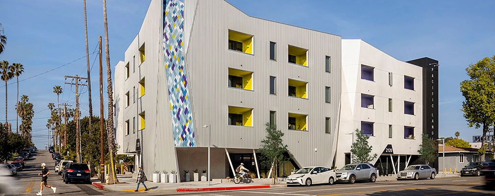 Four-story residential building from across an intersection.