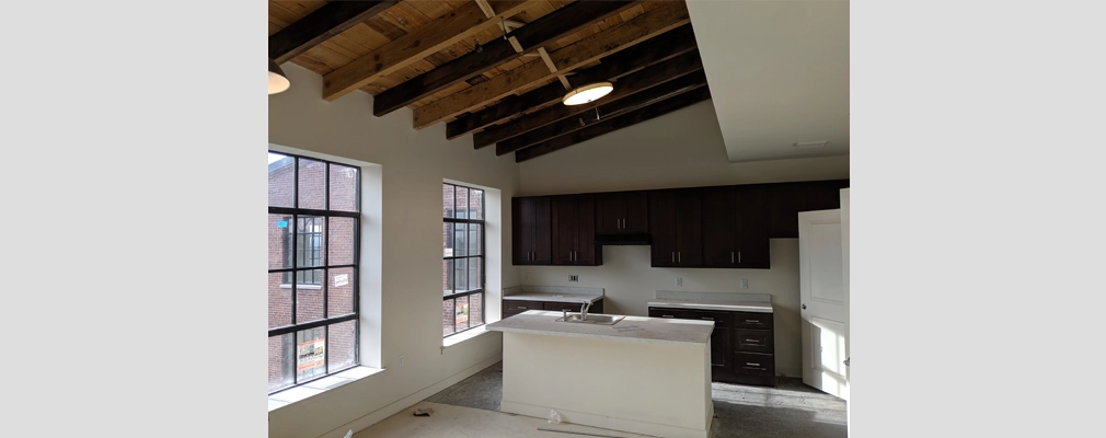 Photo of a kitchen with exposed beam ceiling and an island.