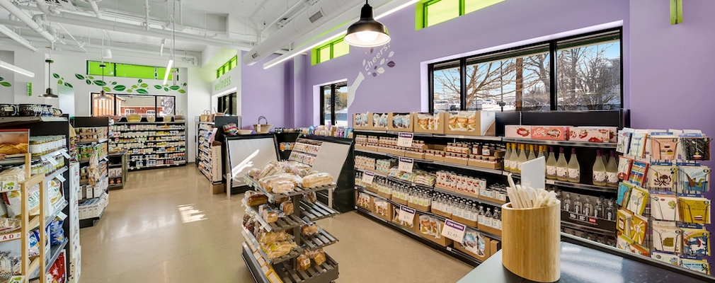 Interior of a grocery store with shelves stocked with food and drinks.