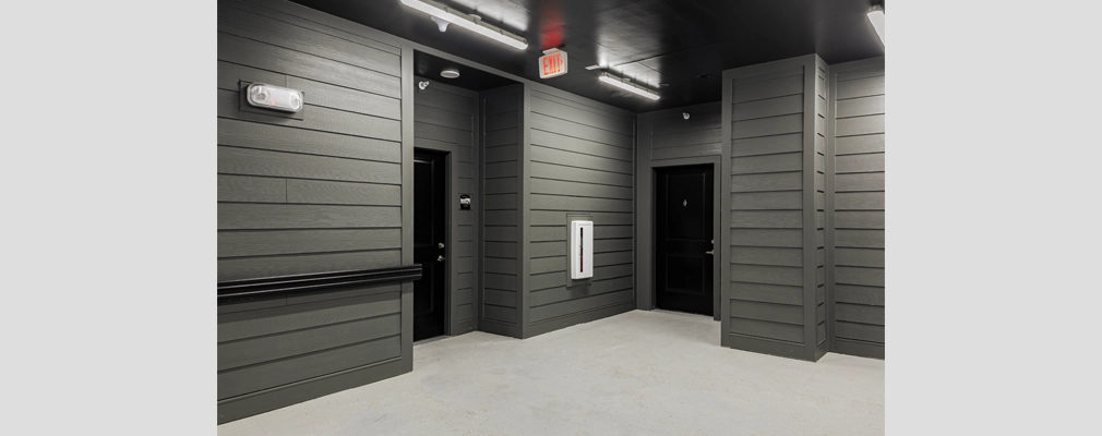 Interior hallway with two apartment doors.