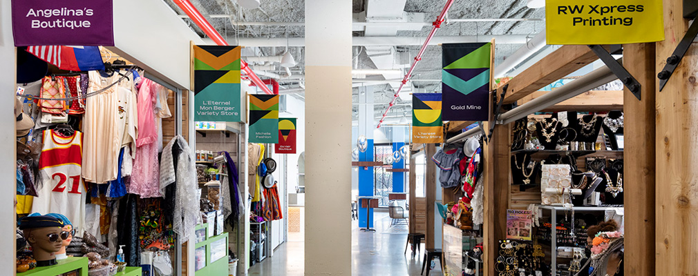 An indoor marketplace with colorful banners and textiles.