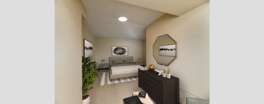 A modern bedroom with light gray carpeting; an L-shaped layout; and high, slanted ceilings.