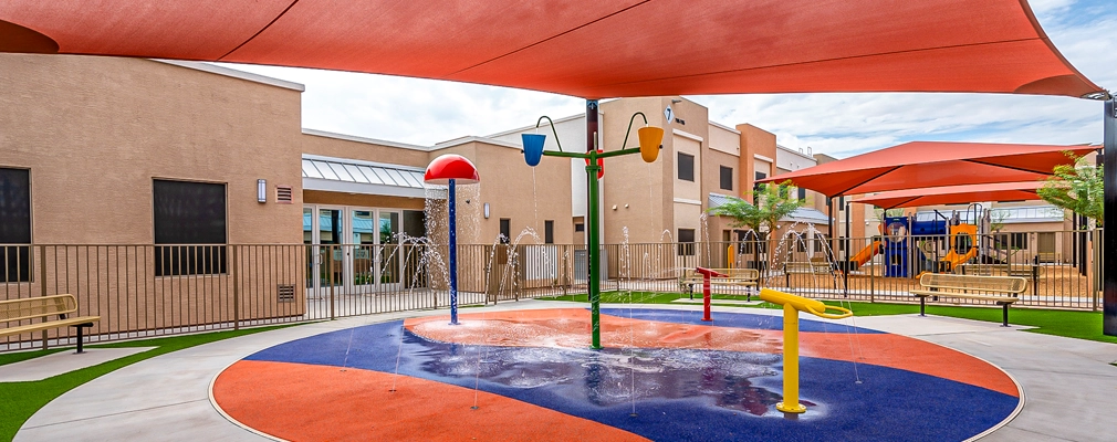 Covered outdoor play area with waterspouts. 