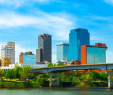 Photo of downtown Little Rock, Arkansas, as seen from across a river with a bridge in the foreground