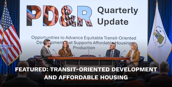 A stage with four panelists sitting at a table. A large screen behind them reads “PD&R Quarterly Update: Opportunities to Advance Equitable Transit-Oriented Development that Supports Affordable Housing Production.”