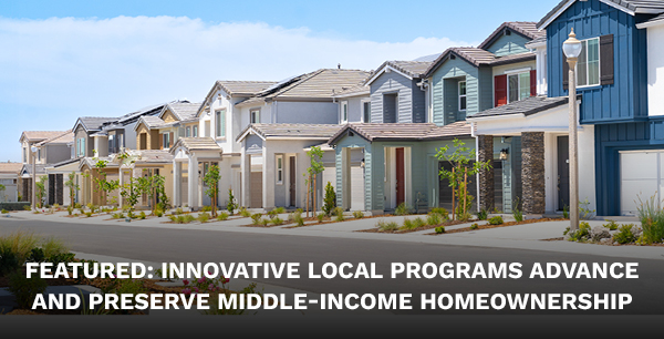 A row of single family homes on a sunny day.