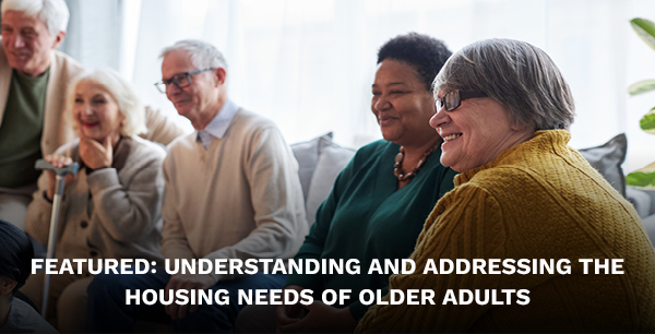 A group of smiling older adults sitting on a couch.