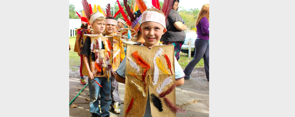 Photograph of six young students dressed as Native Americans in costumes they made.