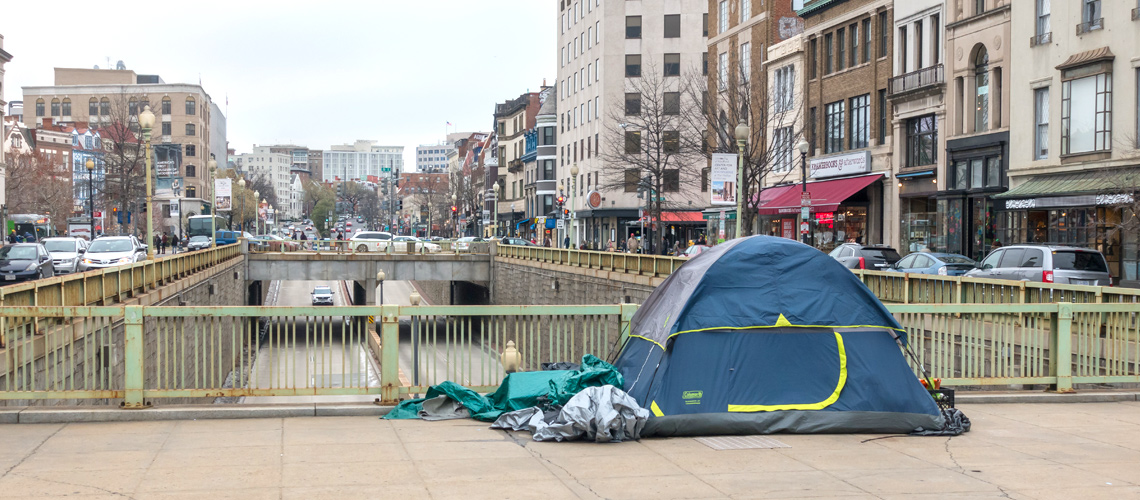 Photograph of a tent on a sidewalk in the Dupont Circle neighborhood of Washington, DC.
