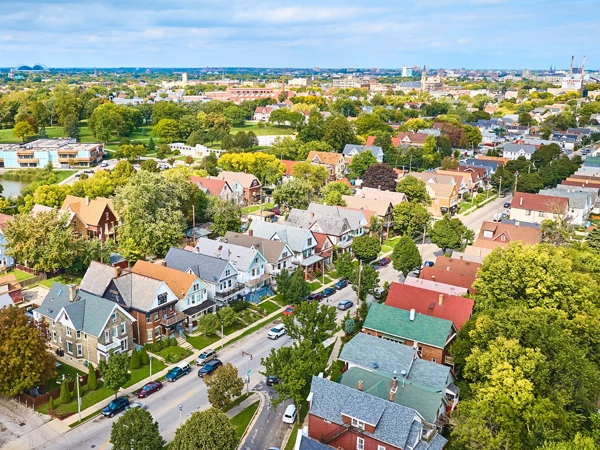 Ariel view of a dense, leafy suburban street.