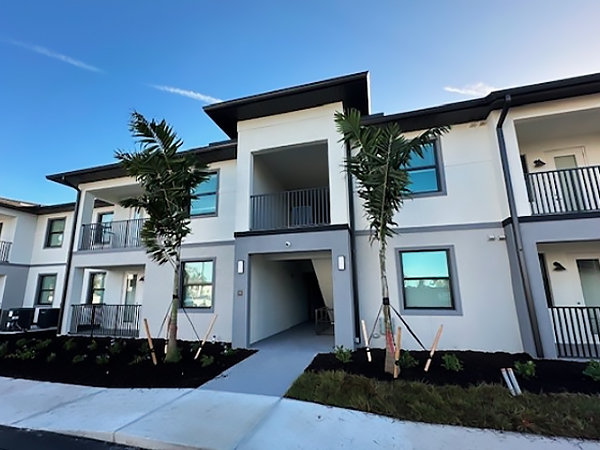 The exterior of a two-story white apartment building.