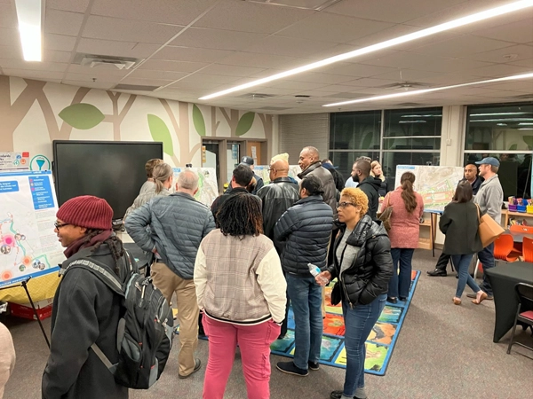 A group of people in a room during a public meeting.