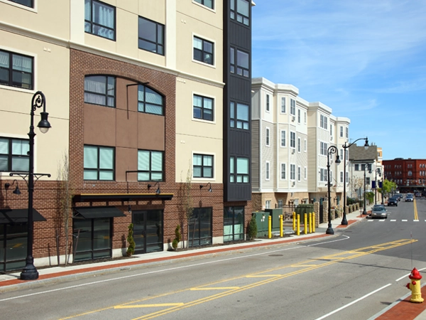 Street-view of Massachusetts with several multi-story buildings.