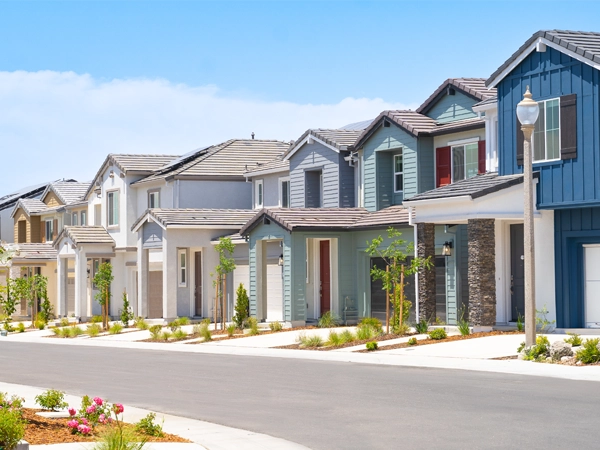 A row of single family homes on a sunny day.